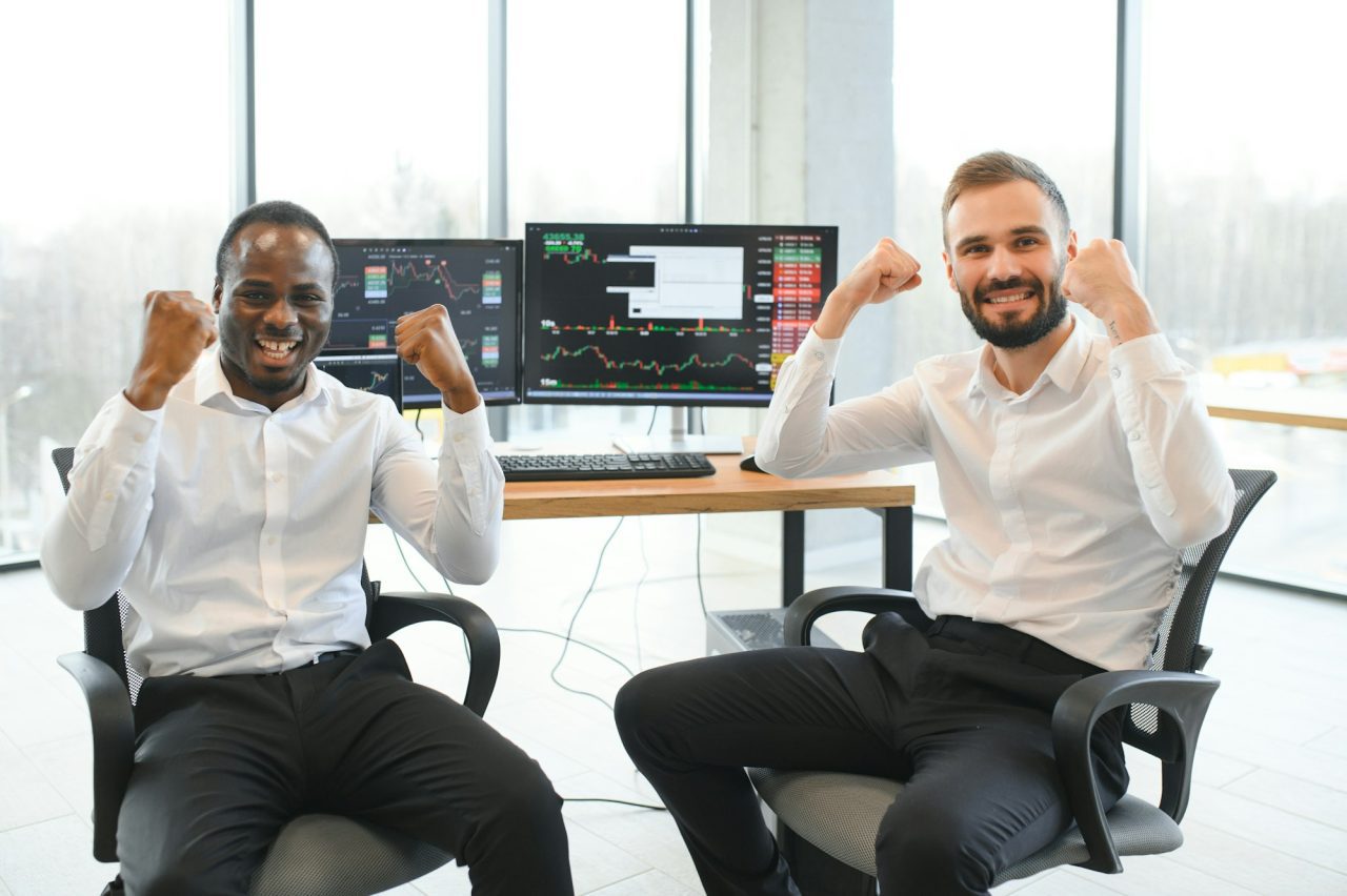 Two stock exchange traders getting profit in Investing currency stock.